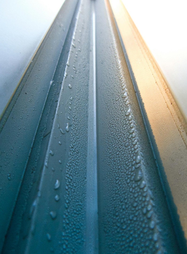 New gutters on a roof with water